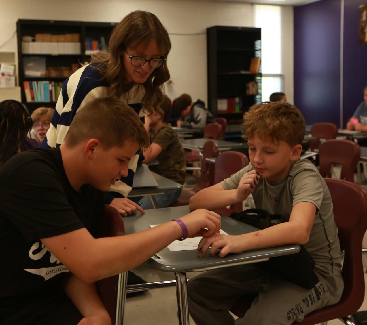 Alyssa Osborne helps students with an assignment.