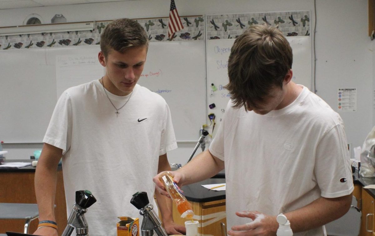 Sophomore Cooper Lane and Junior Owen Lewellyn mix ingredients for lab.
