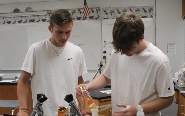 Sophomore Cooper Lane and Sophomore Owen Lewellyn mix ingredients for lab.