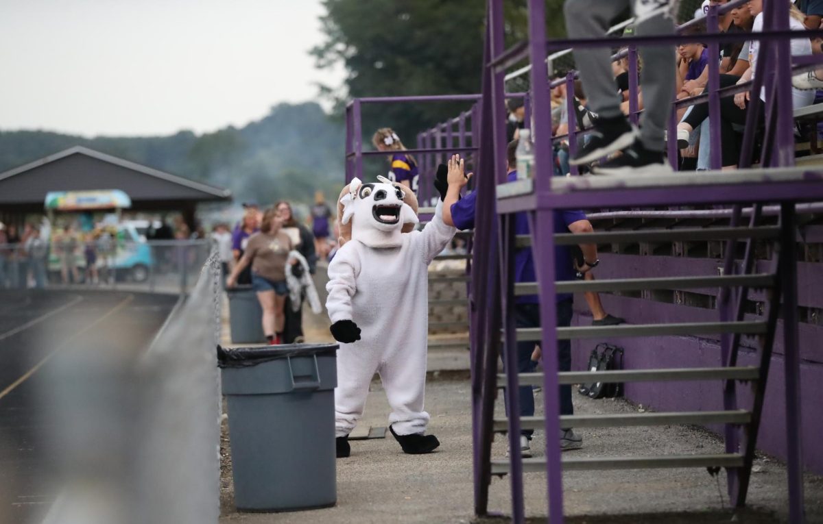 Rocky Ram high fives Assistant Principal Adam Stroud.