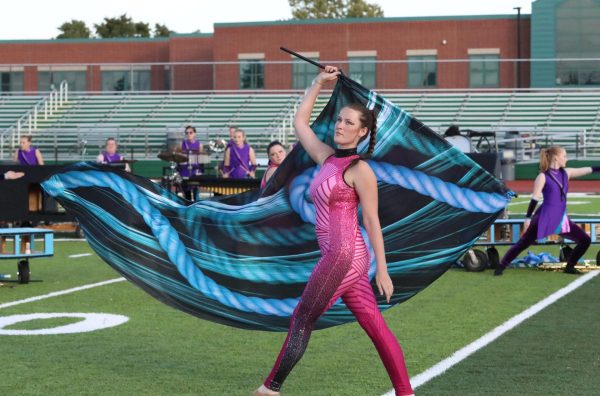 Junior Ava Middleton performs flag work in the opening movement.