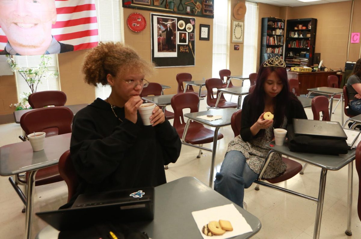 Juniors Aiyanna Hall and Zoey Jenkins enjoy their tea together at their desks.