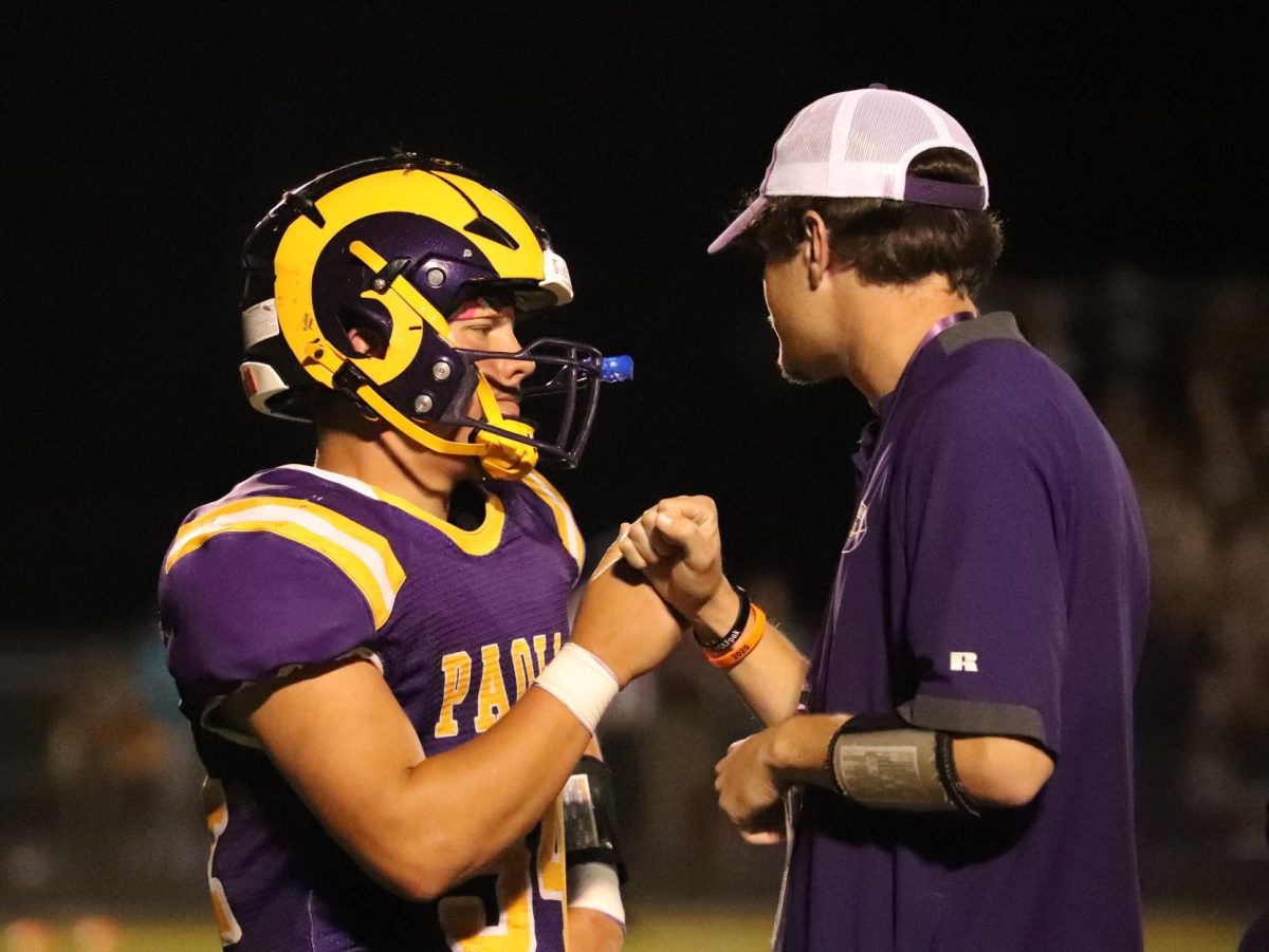Senior Tyler Hannon talks to Coach Little between plays.