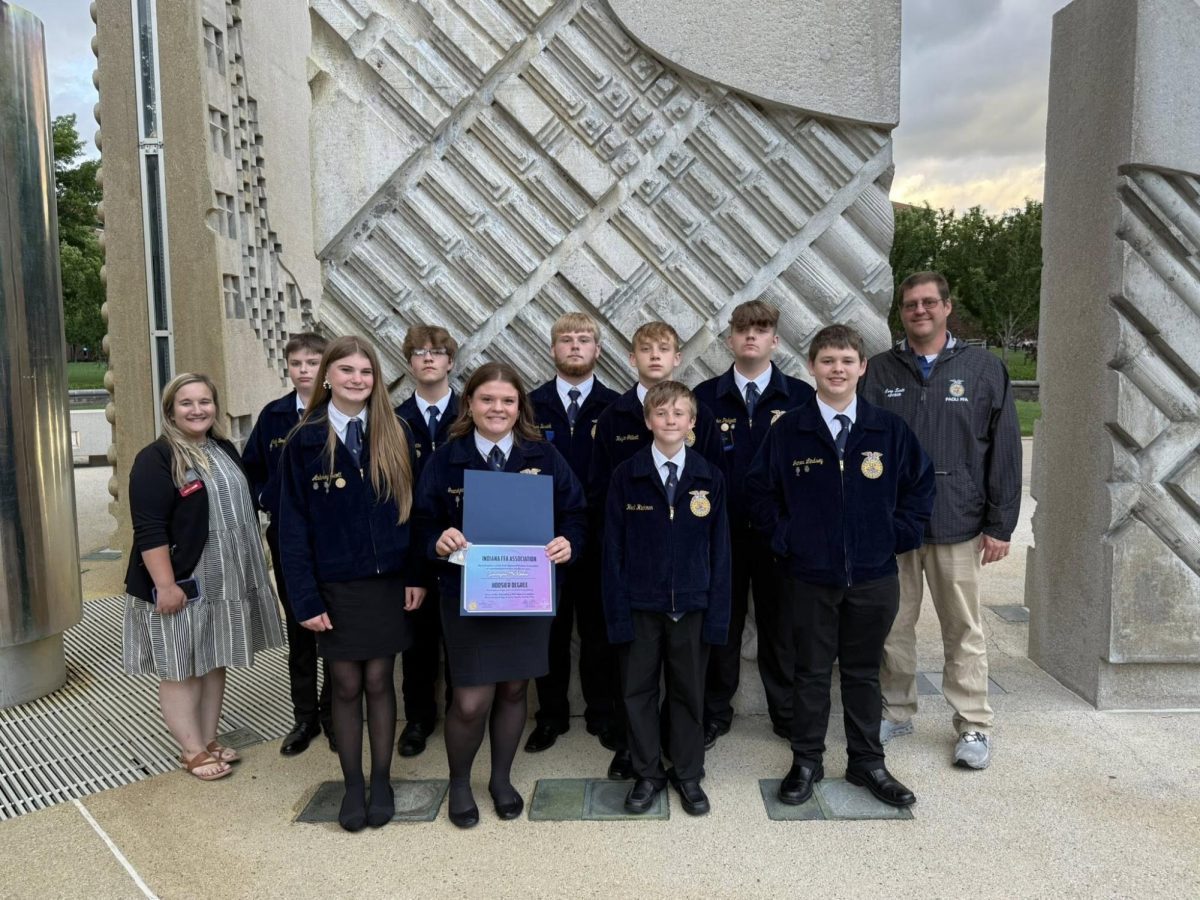 Gracielynn McKibbon, along with other Paoli FFA members, pose with the Hoosier Degree McKibbon won.
