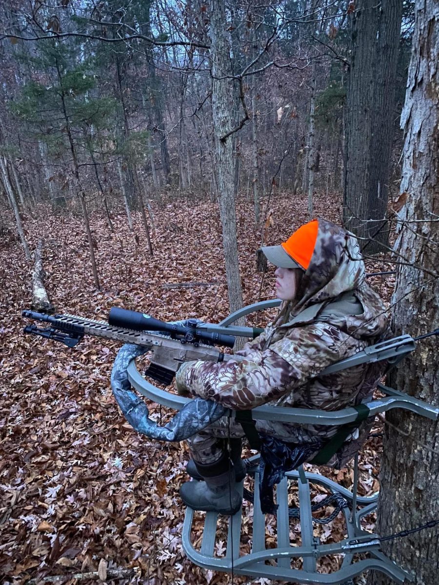Charli Chastain sits in tree stand, waiting to shoot.