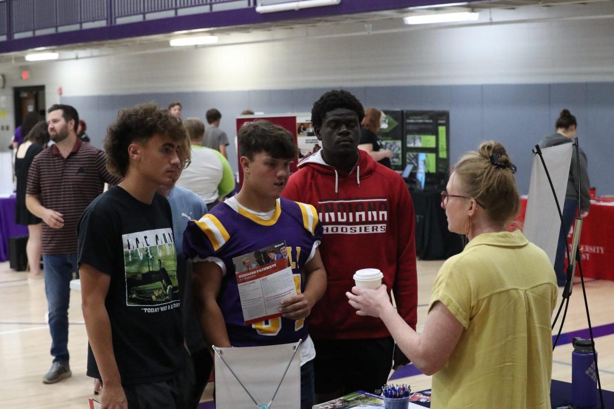Seniors Kirkland Hughes, Tyler Hannon, and Chad Sullivan speak to a college representative.