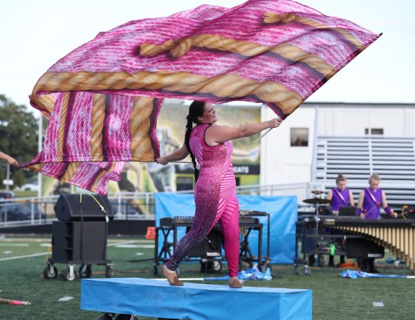 Junior Kyrah Fry performs on top of a prop in movement 3.