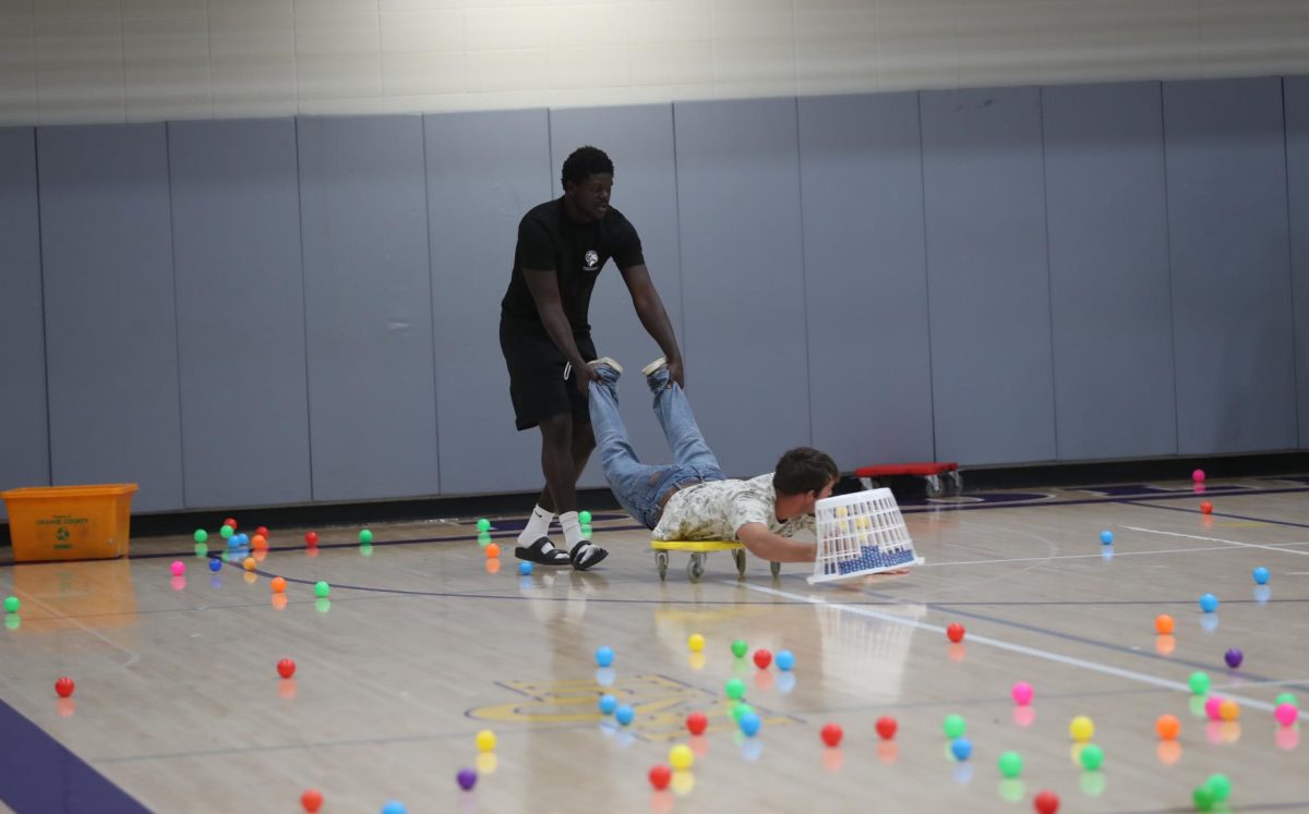 Senior Chad Sullivan pushes senior Coen Brace during the Hungry Hungry Hippo event.