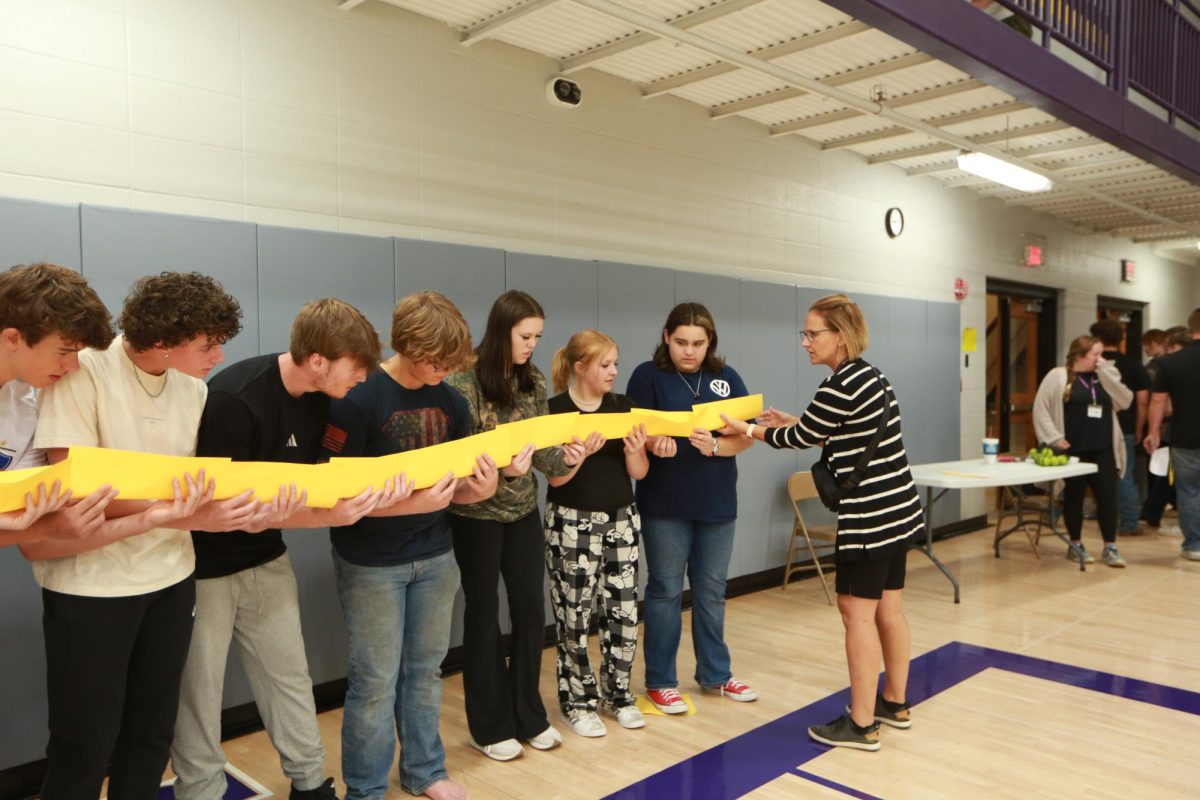 Students in Crystal Shellenberger’s homeroom compete in the Let’s go Team activity. Students were required to get a marble from start to finish without touching it or it falling to the floor.