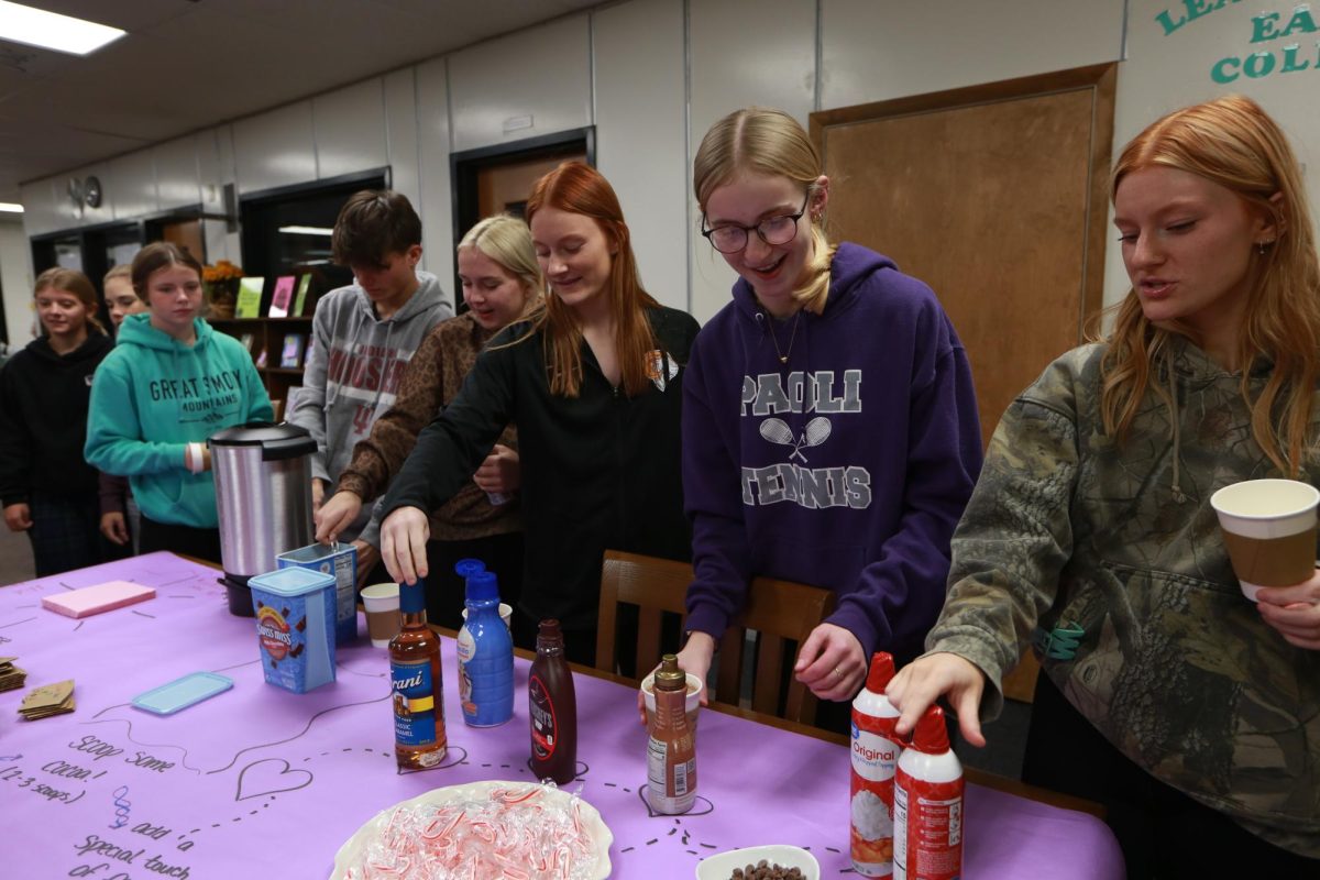 Seniors Dakota Mousty, Tori Patton, Audrey Hall, Aurora Hays, and Ava Hall file in to grab cocoa during the Cocoa with Counselors event on November 13.