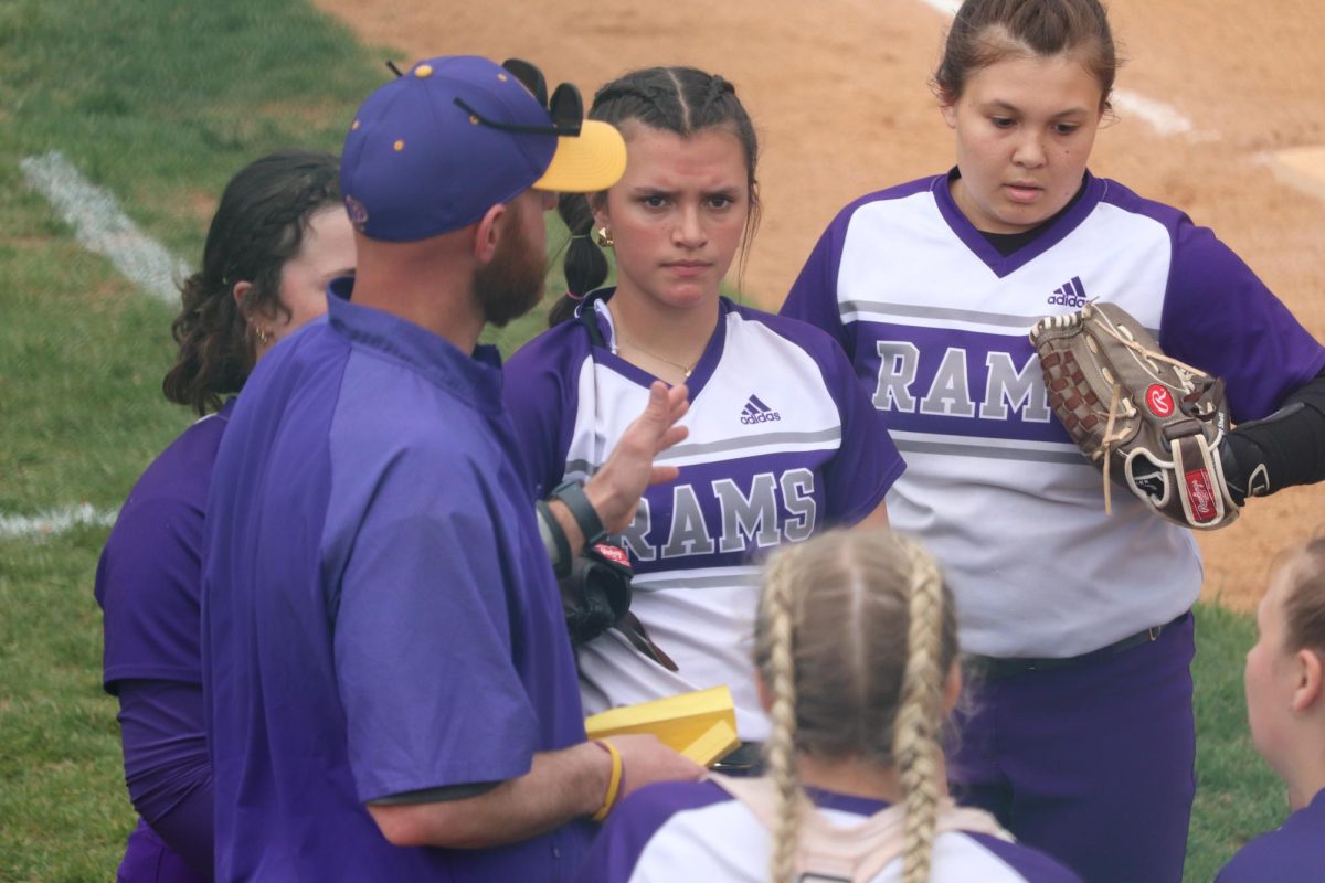 Neil Dittmer talks to his softball team during a timeout. 
