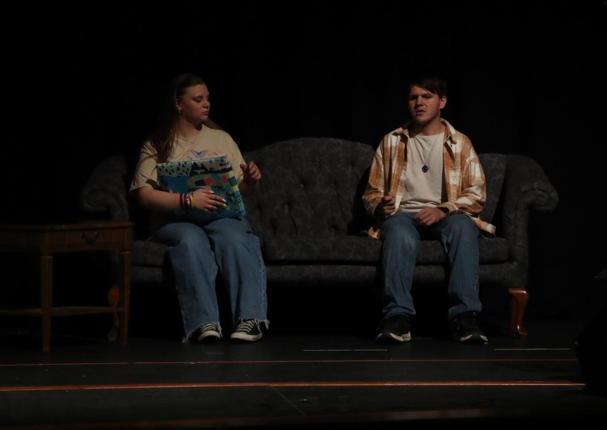 Juniors Piper Frank and Josh Young sing to each other.