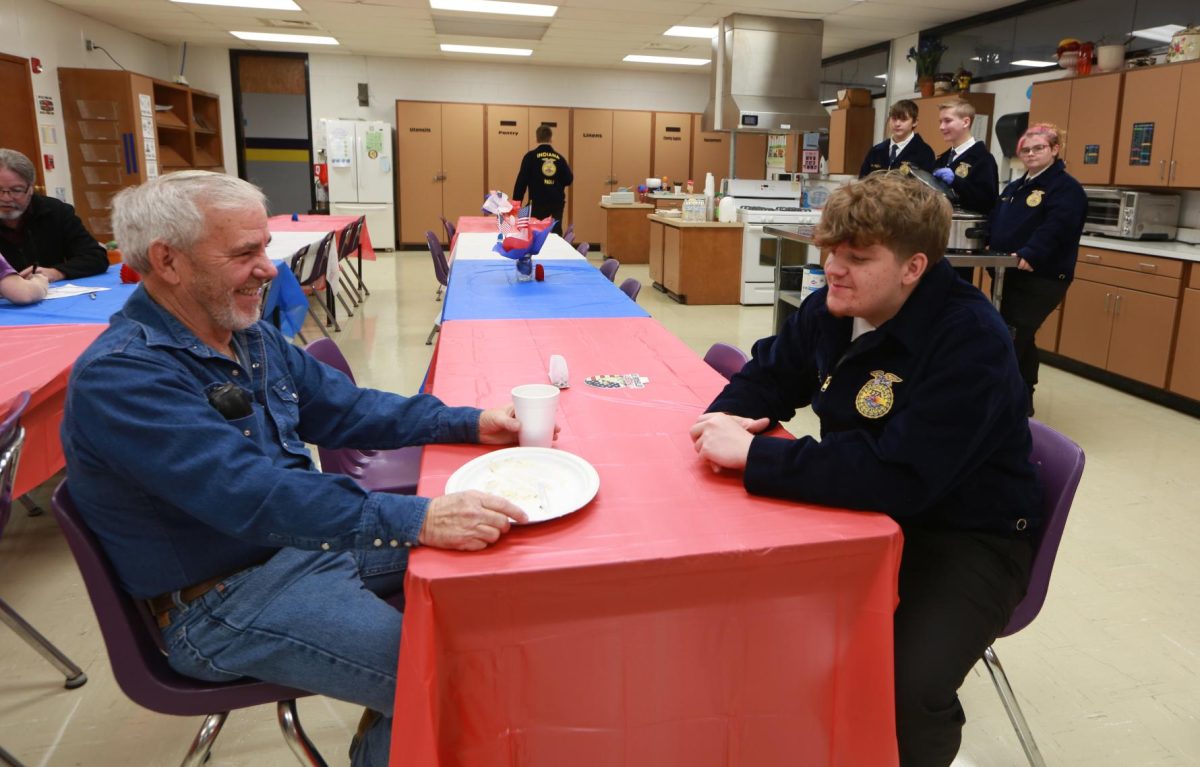 Junior Graydan Padgett socializes during the Veterans Day Breakfast.