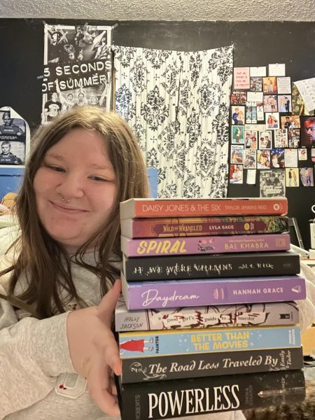 Paityn Norton poses with some of her favorite books.