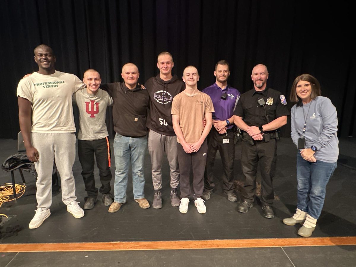 Participating in the 2025 No Shave Event (from left): seniors Chad Sullivan, Aden Crowder, Keegan Cox, Charlie Higgins, Jaxton Deaton, Throop SRO Curtis Garrison, and event coordinator SRO Jon Deaton. Also pictured is Nia Manship who spoke to the students about her experience with cancer.
