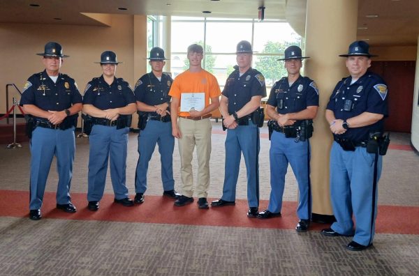 Senior Dane Padgett is pictured with Indiana State Troopers, as well as a certificate of completion for the 2025 State Troopers Youth Services Summer Camp.