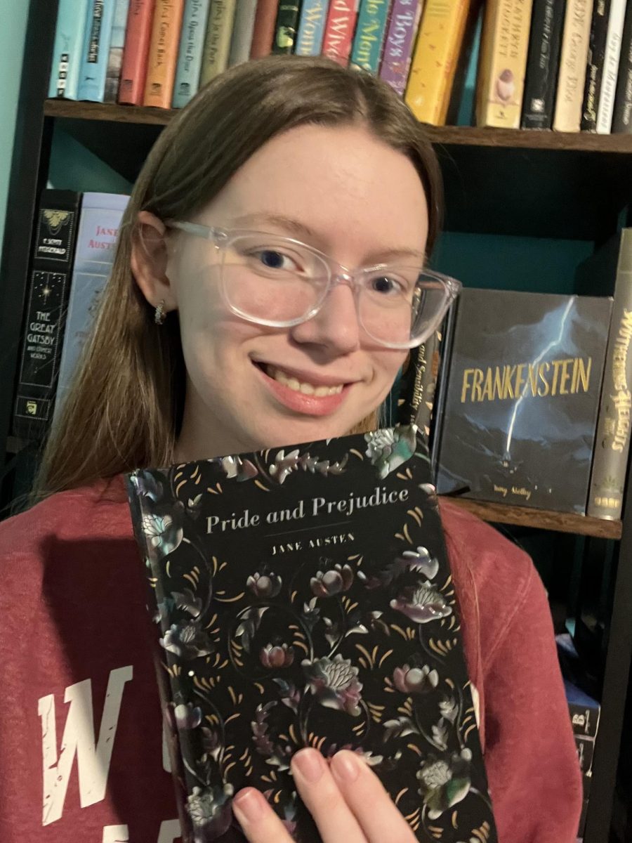 Senior Kayla Barnett poses with her book, Pride and Prejudice by Jane Austin.
