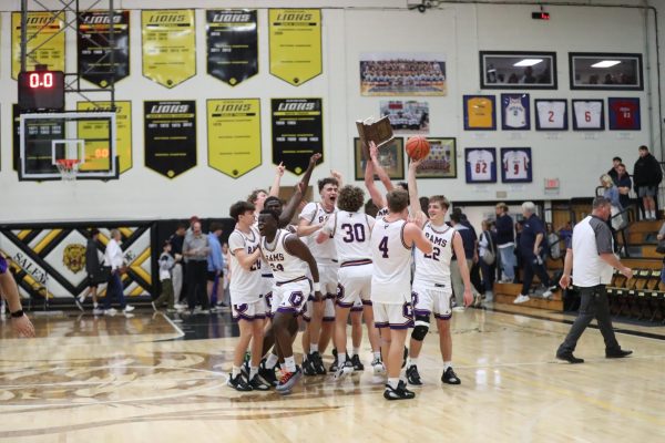 The Varsity Boys Basketball team celebrate their Sectional victory over Providence.