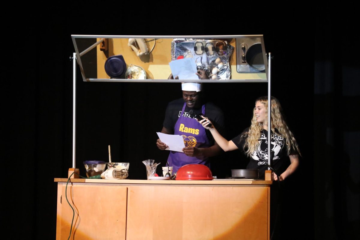 Senior Chad Sullivan raps while baking for his talent with the help of senior Maddie Vernon.