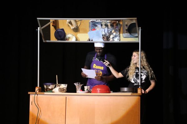 Senior Chad Sullivan raps while baking for his talent with the help of senior Maddie Vernon.